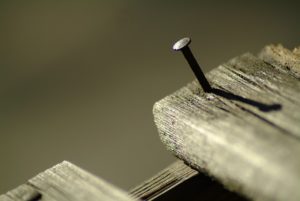 A nail in wooden board